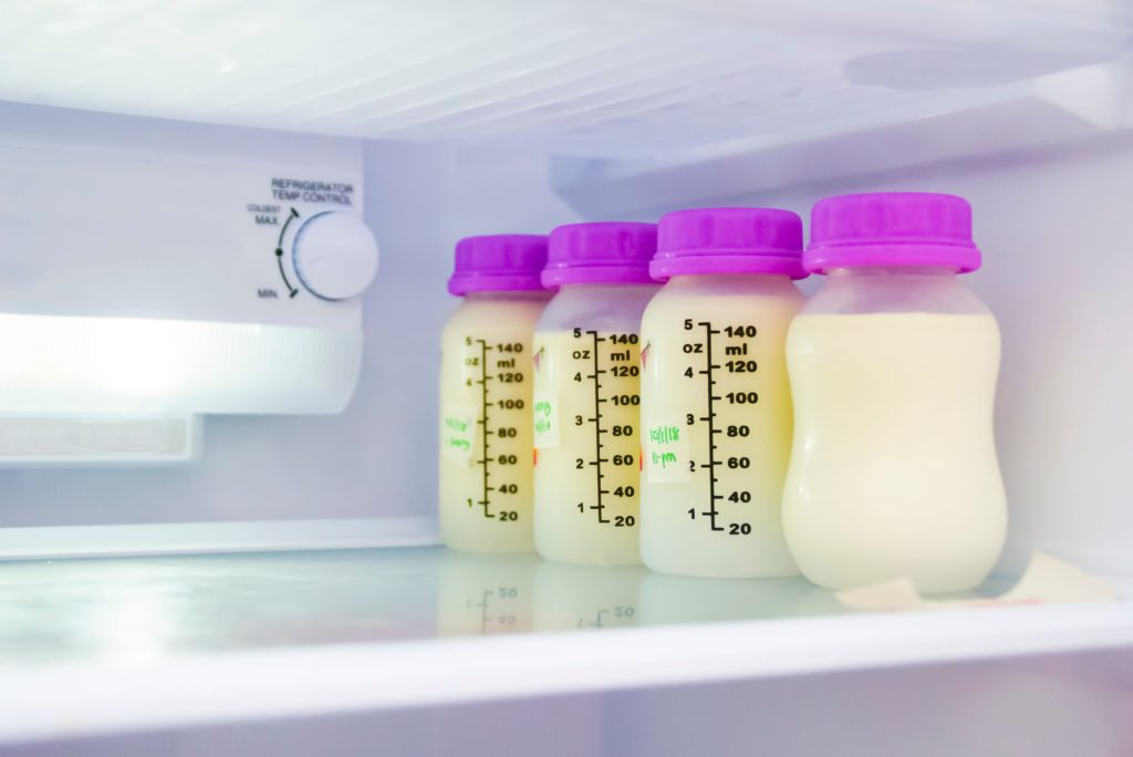 Bottles of breast milk stored in fridge