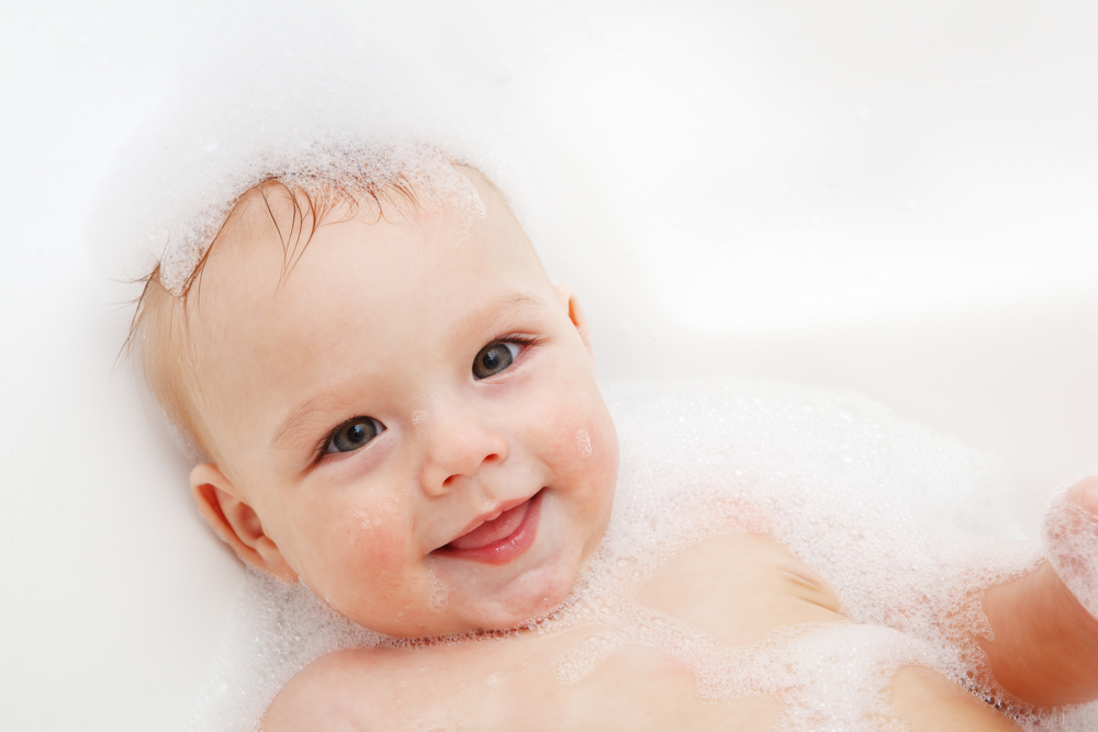 Baby smiling during a baby bath