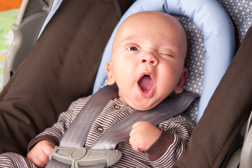Baby yawning whilst sat in car seat