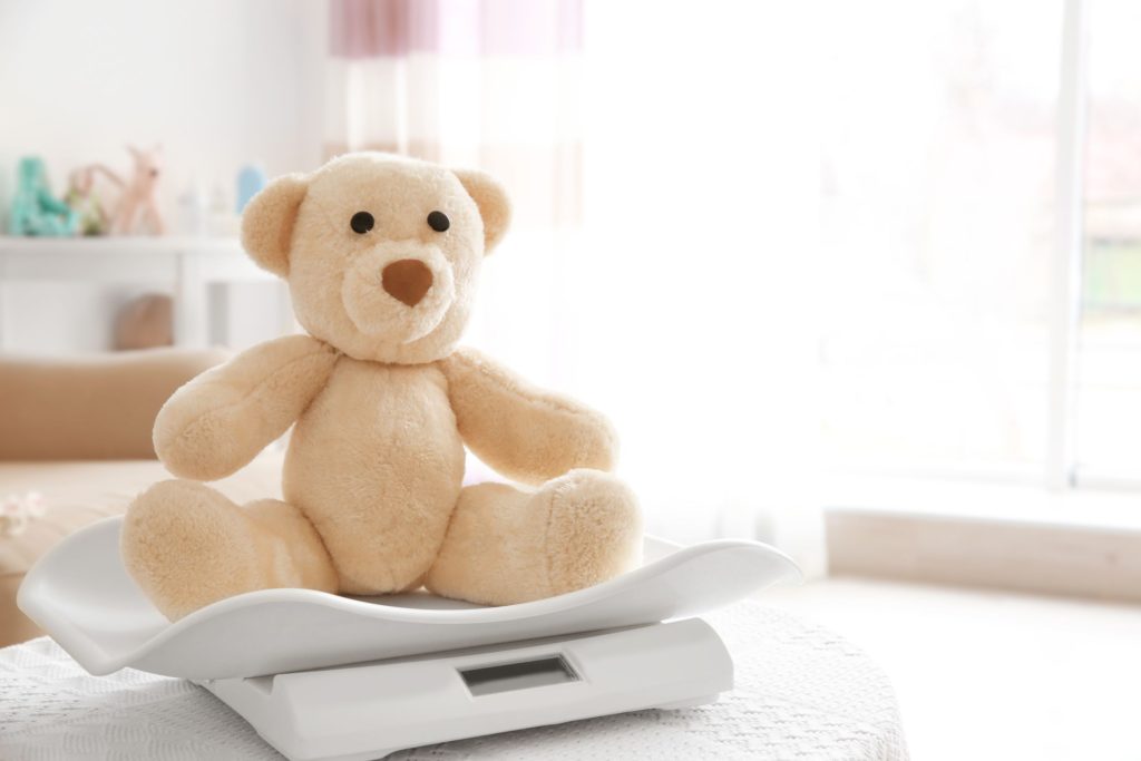 Teddy bear sat on weighing scales