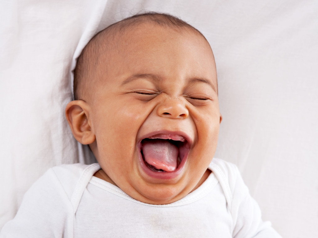 a small baby laughing