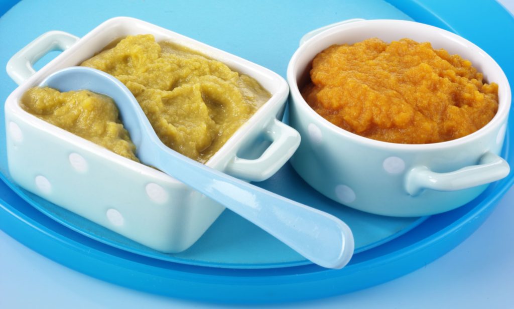 Two portions of baby food, one orange and one green