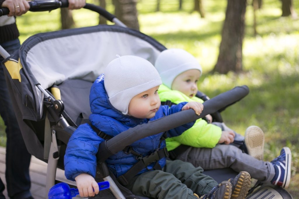 Twin babies in a twin pushchair 