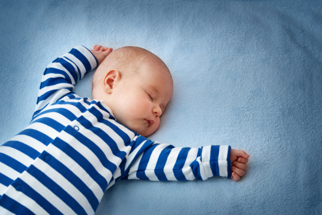Baby asleep in a blue and white striped onesie 