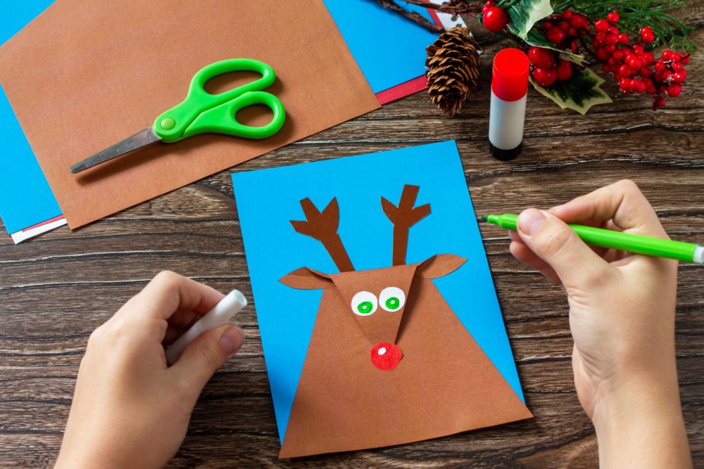 Child making a reindeer Christmas card