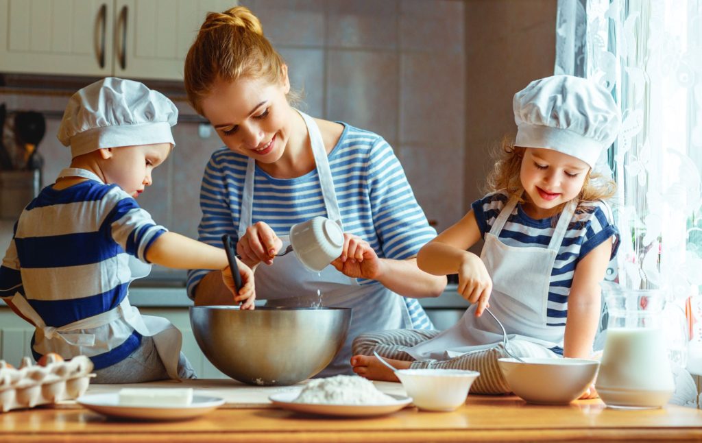 Mum and children baking together