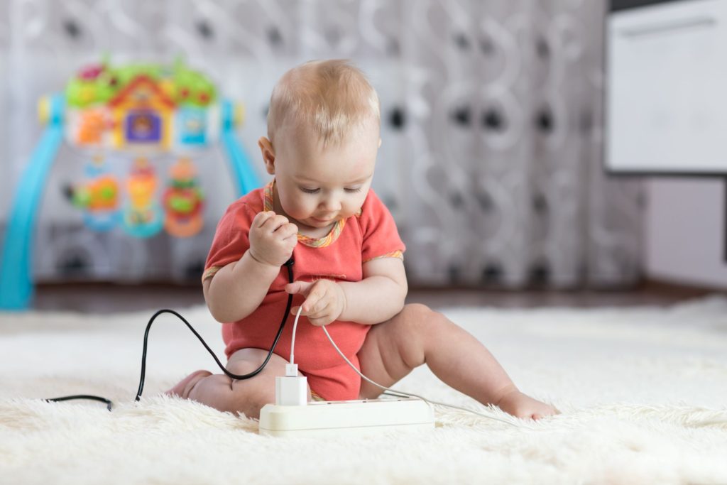 Baby holding wires in their hand 