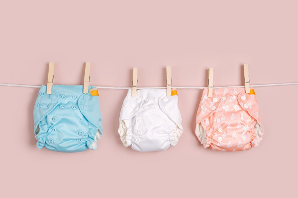 Blue, white and pink nappy on washing line hooks