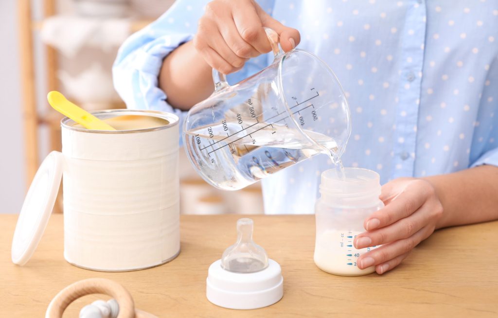 Parent preparing formula milk