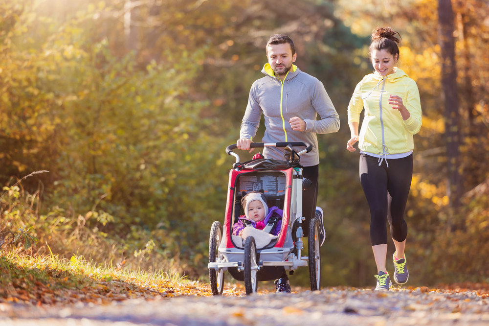 Beautiful,Young,Family,With,Baby,In,Jogging,Stroller,Running,Outside