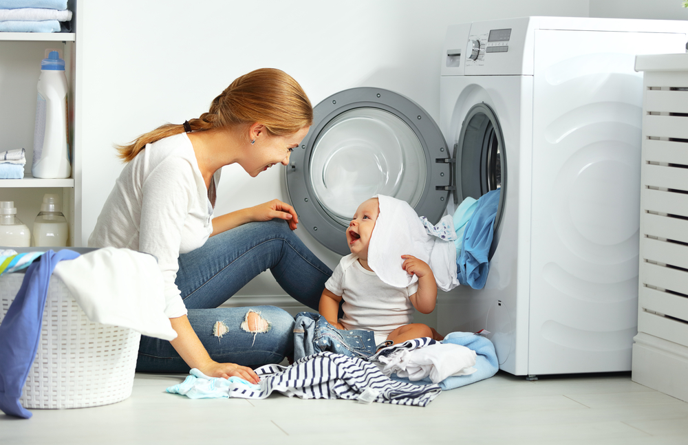 Mother,A,Housewife,With,A,Baby,Engaged,In,Laundry,Fold
