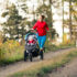 Running,Mother,With,Child,In,Stroller,Enjoying,Motherhood,At,Autumn
