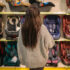 Woman,Standing,Aganst,Shelf,With,Child,Car,Seats