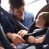 Safety,First.,A,Young,Father,Strapping,His,Baby,Into,A